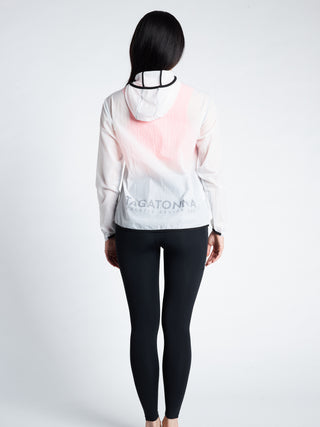 Woman wearing a minimalistic TAGATONNA Athletic Design Lab  with the lower back logo white transparent jacket with and black leggings