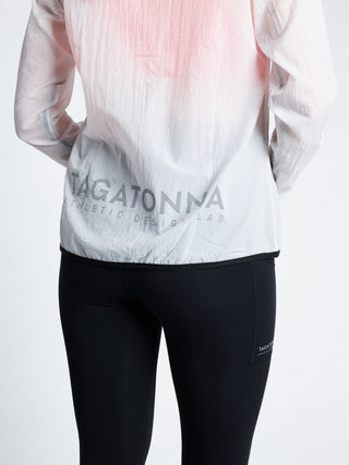 Woman wearing a white transparent  jacket with TAGATONNA ATHLETIC DESIGN LAB logo on lower back 