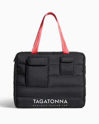 Black puffer bag with coral handles and 'TAGATONNA'  reflective branding on a white background